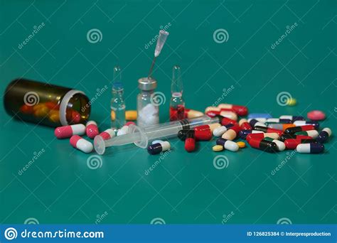 medication capsules spilled on blue pastel coloured background medication and prescription