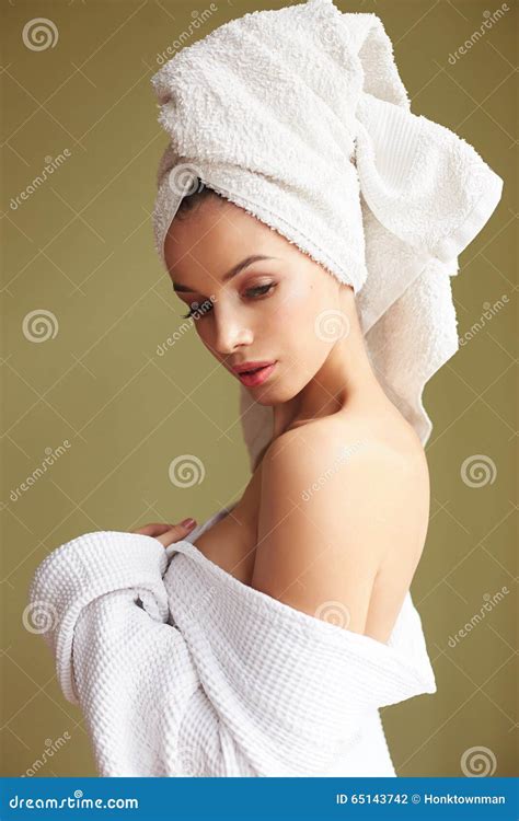 Beautiful Woman In Bath Robe With A Towel On Her Head Looking Thoughtfully Into The Camera Stock