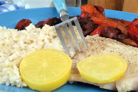 Diet Meal With Fish Rice And Vegetables Served On A Plate Stock Photo