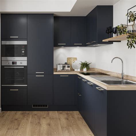Grey burford kitchen with white corian worktops and subway tiles. Greenwich Navy Kitchen | Fitted Kitchens | Howdens
