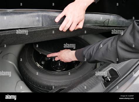 Spare Wheel In The Trunk Auto Mechanic Hands Stock Photo Alamy
