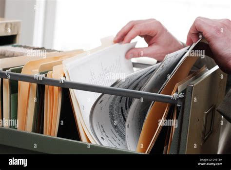 Searching Through Paperwork In A Filing Cabinet Stock Photo Alamy