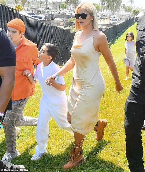 Khloe Kardashian Goes Braless In A Cream Silk Slip Dress As She Spends