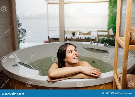 Woman Having A Spa Day Moment In Modern Bathroom Indoors Relaxing At Home In The Hot Tub Bath