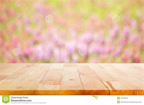 Wood Table Top On Blur Flower Garden Background Stock