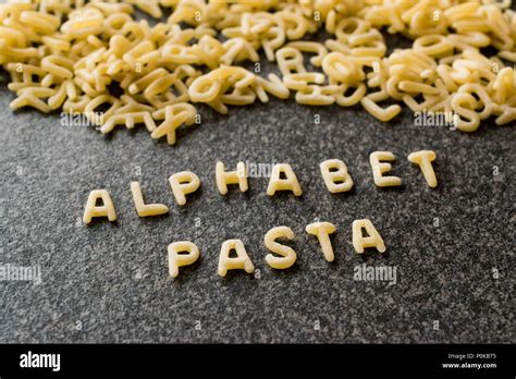 Raw Alphabet Pasta Is Written With Letters On Granit Grey Surface