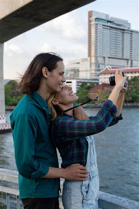 Cute Interracial Couple Taking A Selfie At The Bridge By Stocksy Contributor Jovo Jovanovic