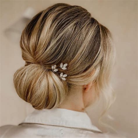 43 Stunning Updo Hairstyles 2022 Low Bun With Floral Hair Pin