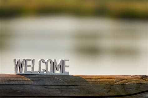 Welcome Sign On Outdoor Background At Sunset Stock Photo Download