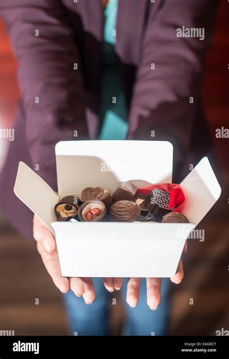 Hands Holding A Box Of Chocolates Close Up Stock Photo Alamy