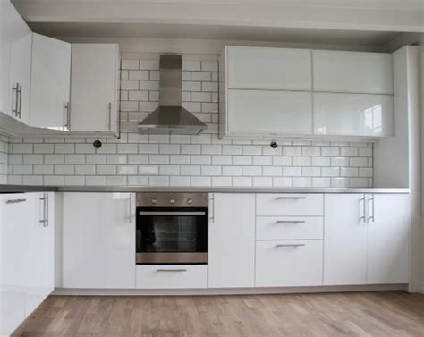 Built to last through years of splashes and steamy showers. IKEA Ringhult kitchen in gloss white. | Ikea white kitchen cabinets, White modern kitchen, White ...