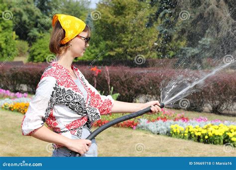 Woman Watering The Flowers Stock Photo Image Of Green 59669718