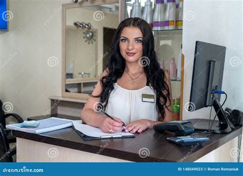 Beautiful Woman Receptionist Smiling At Her Workplace Stock Image