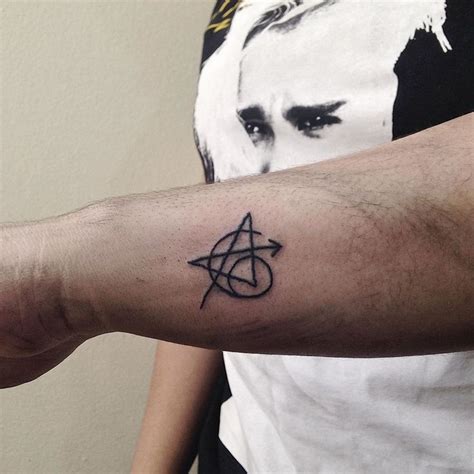 A Person With A Tattoo On Their Arm