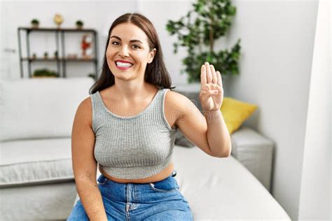 Young Beautiful Hispanic Woman Communicate With Deaf Language Sitting