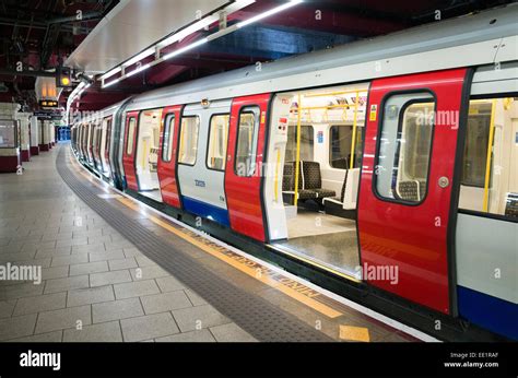 A London Underground Train At A Platform In A Station In Britain Stock