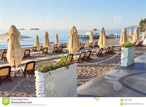Scenic View Of Private Sandy Beach With Sun Beds And Parasokamy The Sea And Mountains Resort