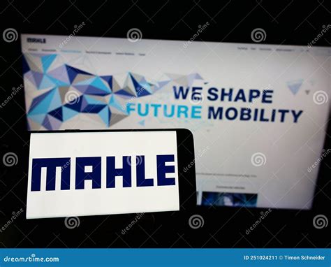 Person Holding Cellphone With Logo Of German Automotive Supplier Mahle