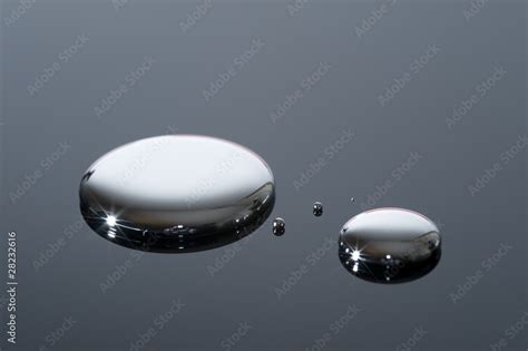 Droplets Of Mercury On A Reflective Surface Stock Photo Adobe Stock