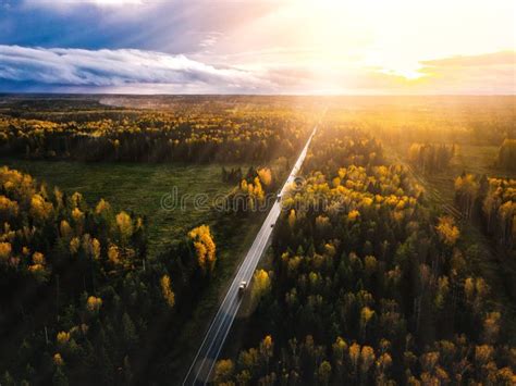 Aerial View Of Road In Beautiful Autumn Forest At Sunset In Rural