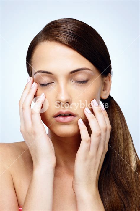 Graceful Woman Gently Caressing Her Face Royalty Free Stock Image