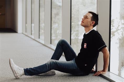 Young Man Sitting On Ground Stock Photo Free Download