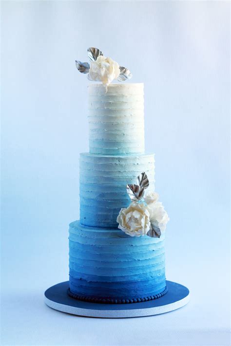 Blue Ombre Buttercream Wedding Cake With White Sugar Flowers And Silver