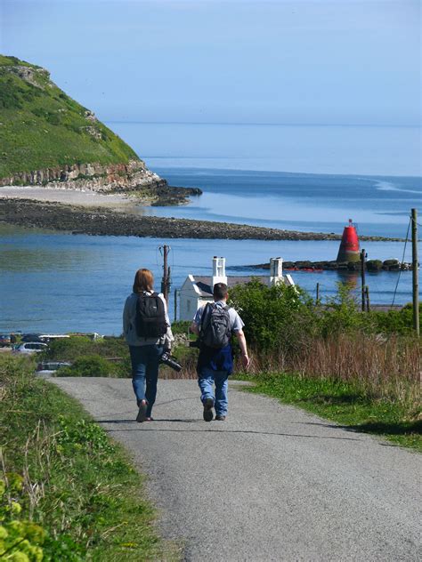 Isle Of Anglesey Coastal Path Walkers Going Down To Penmon Point By