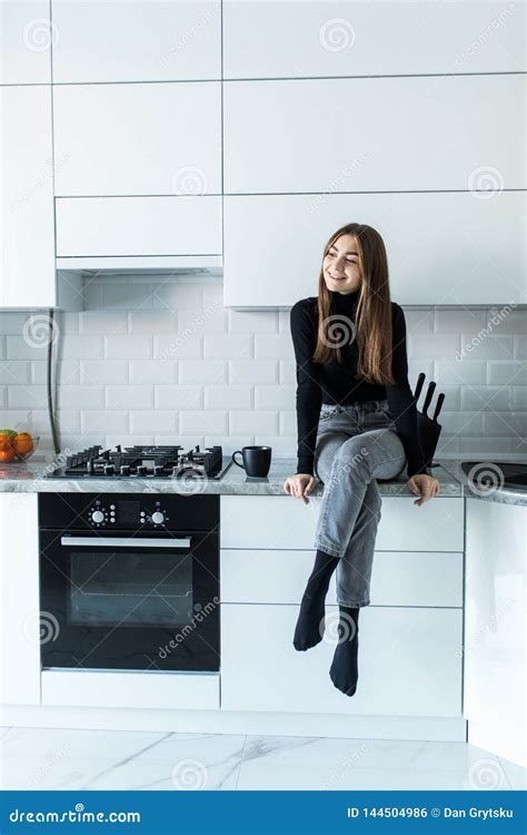 Attractive Woman Sitting On Kitchen Counter Young Housewife Relaxing