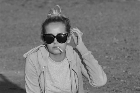 Premium Photo Portrait Of Woman In Sunglasses Smoking Cigarette Outdoors