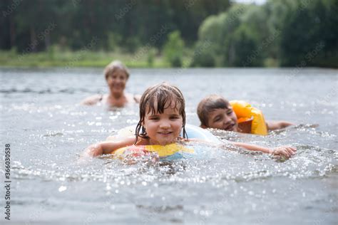Happy Kids Swimming In The Lake On Hot Summer Day Kids Learn To Swim