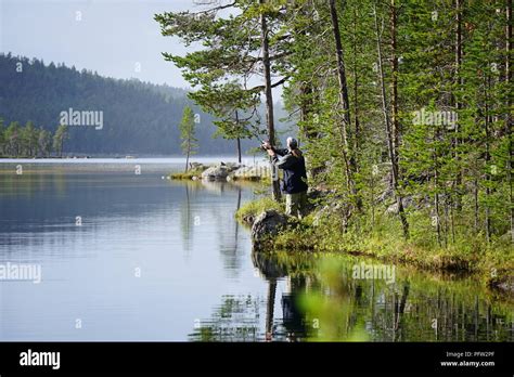 Man Fishing At The Lake In Lapland Finland Stock Photo Alamy