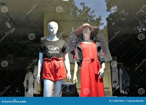 Showcase Of A Clothes Store With Mannequins Dressed With Fashion