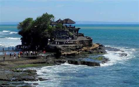 During the day, an array of different brightly colored parasols and beanbags line the sand. List of best places to visit in Bali Indonesia