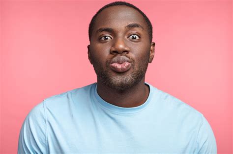 Pleasant Looking African American Man Rounds Lips Going To Recieve