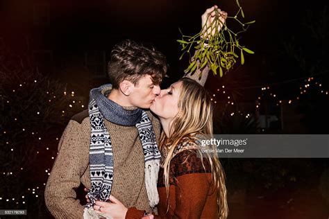 Couple Kissing Outdoors Under Mistletoe Photo Getty Images