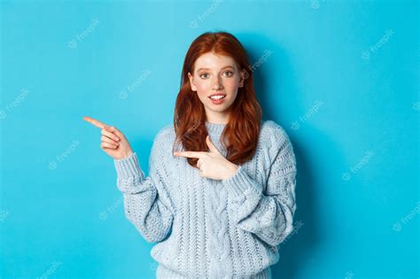 Premium Photo Image Of Pretty Redhead Girl In Sweater Pointing