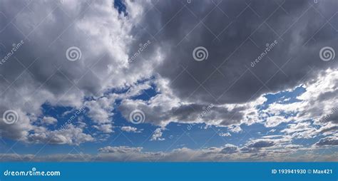 Silver Clouds Full Of Rain Floating In Blue Sky Panorama Stock Photo