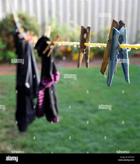 Wet Clothes Hanging On A Washing Line With Droplets Of Rain On The