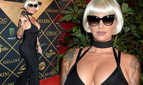amber rose nearly bursts out of daringly low cut jumpsuit at maxim hot 100 party daily mail online