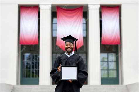 Premium Photo Graduating Student Holding Blank Frame