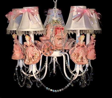 A Chandelier With Pink And White Decorations On It