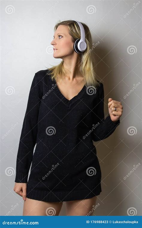 Portrait Of Beauty Young Caucasian Blonde Hair Woman Listen Music On Headphone On White