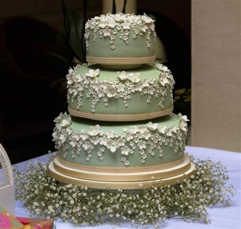 Sage Green Wedding Cake With Delicate White Blossoms On A Bespoke