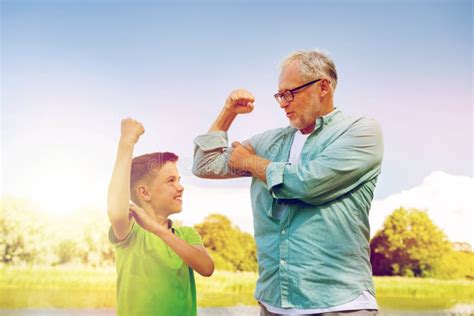 Happy Grandfather And Grandson Showing Muscles Stock Image Image Of