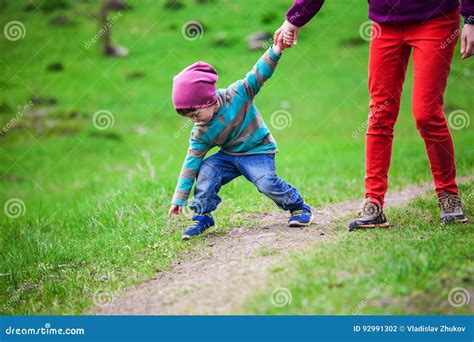 The Boy Walks With His Mother Through The Meadow Stock Photo Image