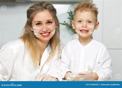 Mom And Boy In The Kitchen Smeared Their Face With Flour Stock Image