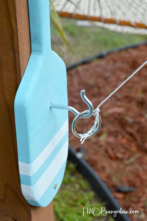 You can make different size holes for different prize levels. Freestanding DIY Hook and Ring Game Tutorial - H2OBungalow