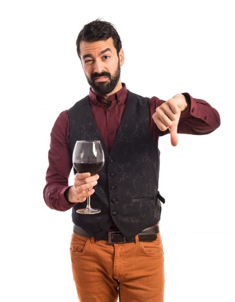 In england, wine glasses have ballooned seven times larger from the 1700s to current times, per a december 2017. Man wearing waistcoat holding a wine glass | Free Photo