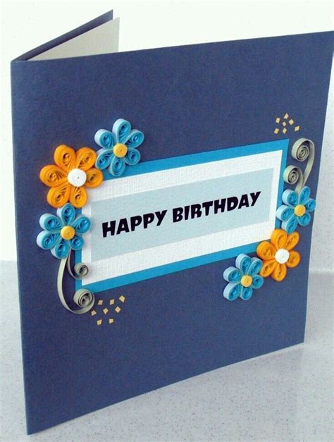 A Blue Birthday Card With Flowers On It